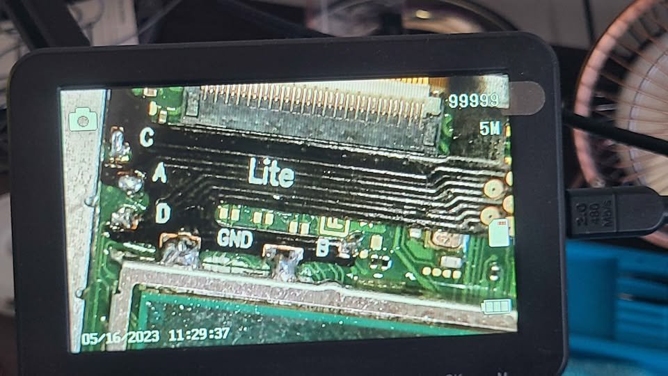 Microscope view of a Switch Lite board with points C, A, D, GND and B soldered